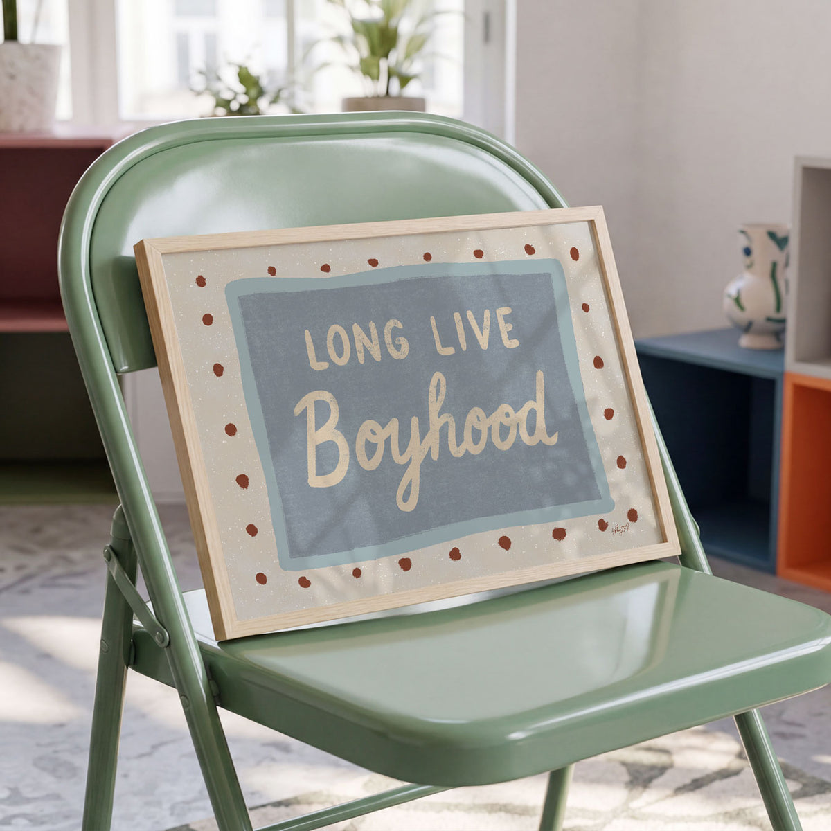 Landscape poster with the hand lettered words long live boyhood on a blue panel