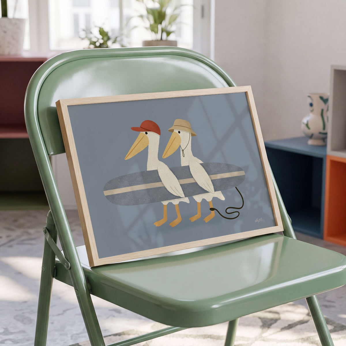 Landscape poster of two pelicans in caps carrying a surfboard on a slate blue background