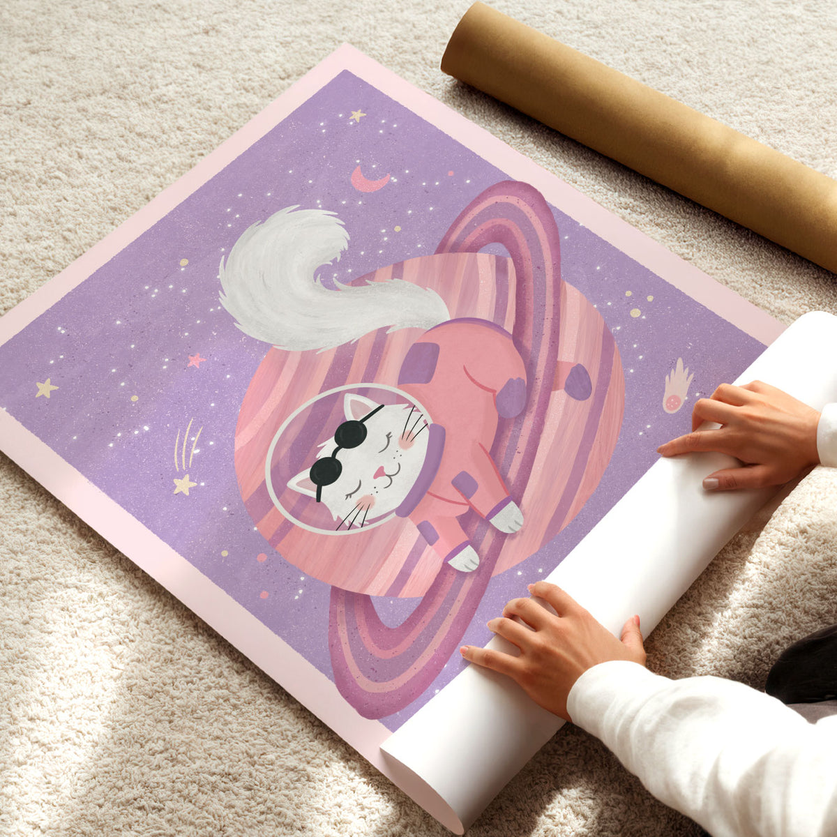 Illustrated poster of a white cat in a coral spacesuit resting on a pink ringed planet in a lilac sky