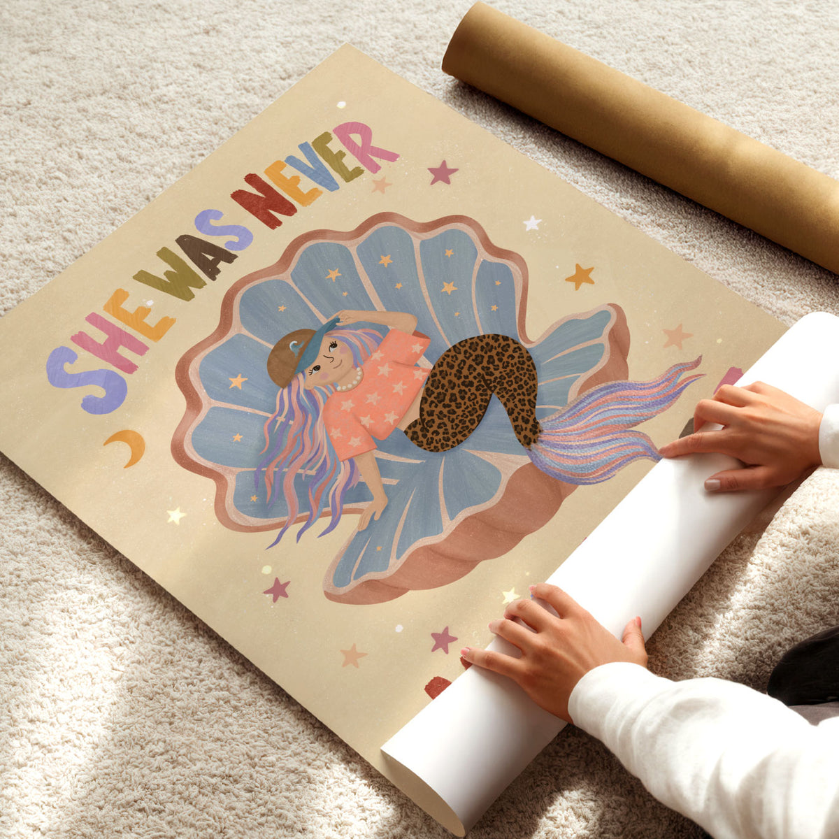 Illustrated poster of a mermaid in a shell wearing a cap with the words she was never made to fit