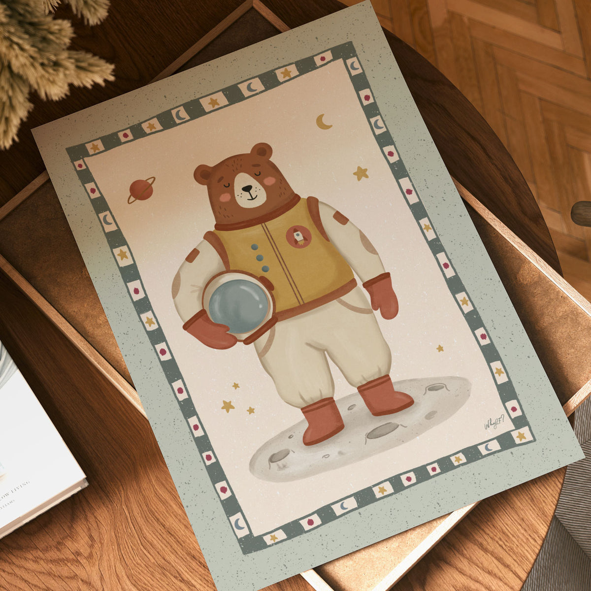 Illustrated poster of a brown bear in a spacesuit standing on the moon inside a star patterned border
