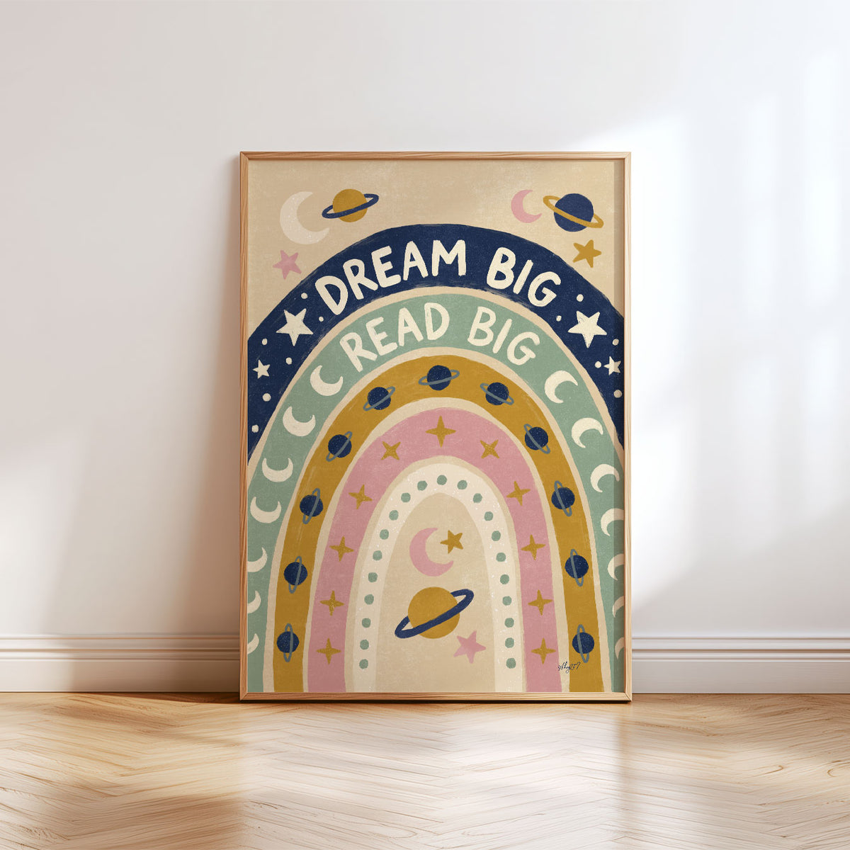 Illustrated poster of a rainbow filled with planets and stars lettered dream big read big