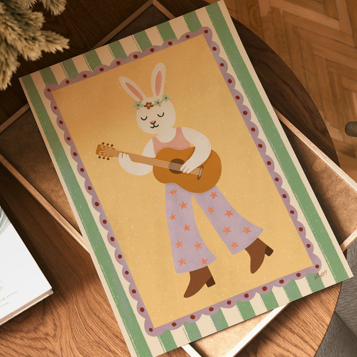 Playful white rabbit playing guitar while wearing a floral headband and blue star-pattern trousers.