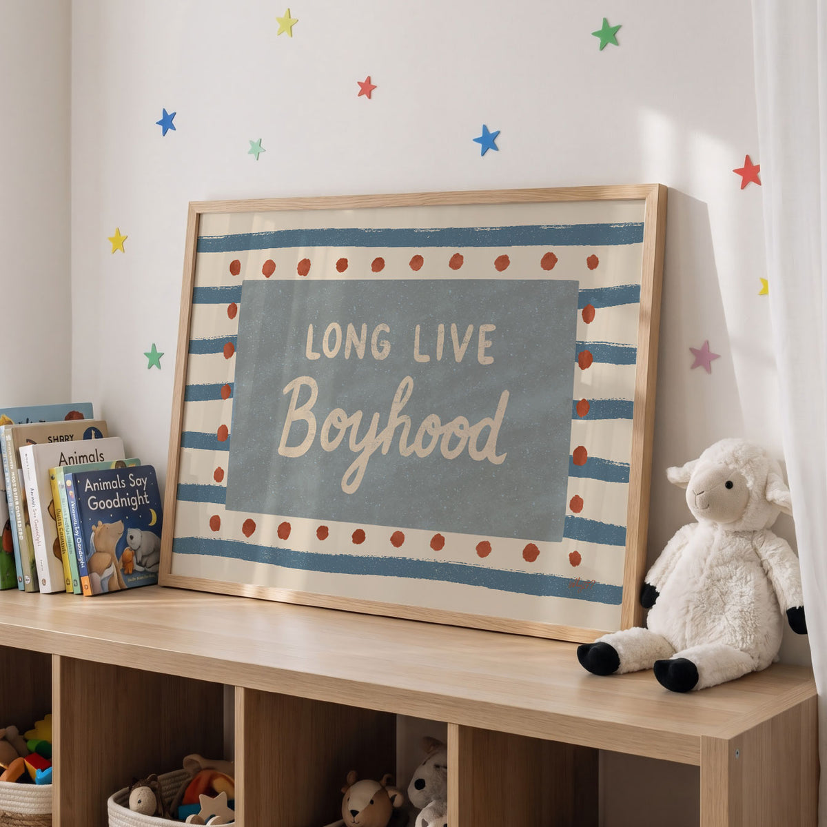 Landscape poster with the words long live boyhood on a blue panel over stripes