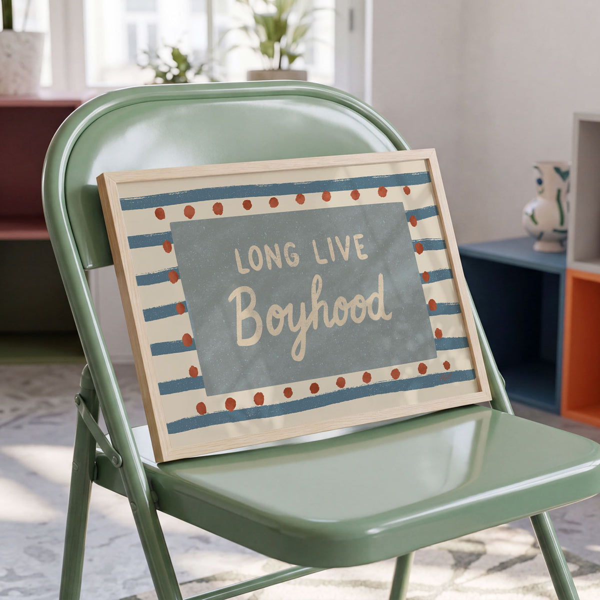 Landscape poster with the words long live boyhood on a blue panel over stripes