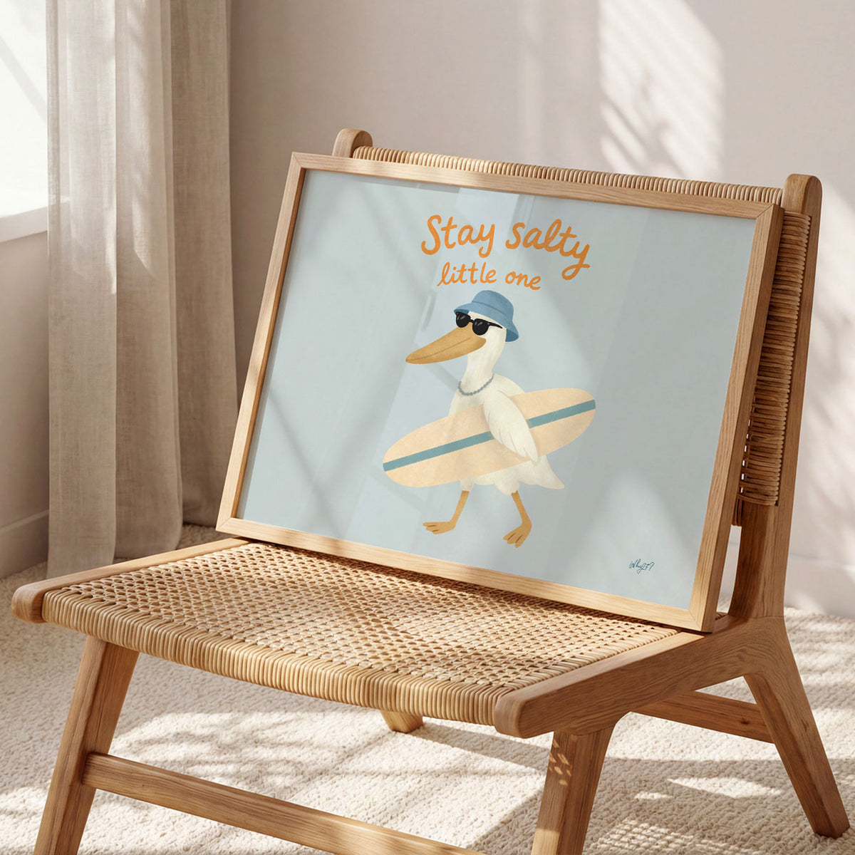 Landscape poster of a pelican with a surfboard under the words stay salty little one