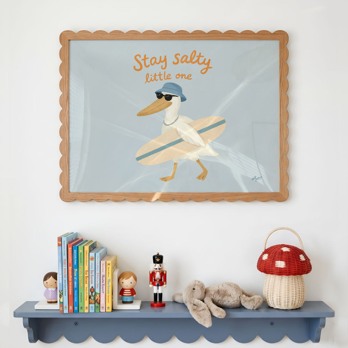 Landscape poster of a pelican with a surfboard under the words stay salty little one