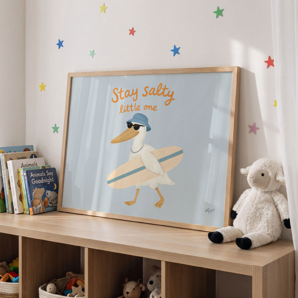 Landscape poster of a pelican with a surfboard under the words stay salty little one