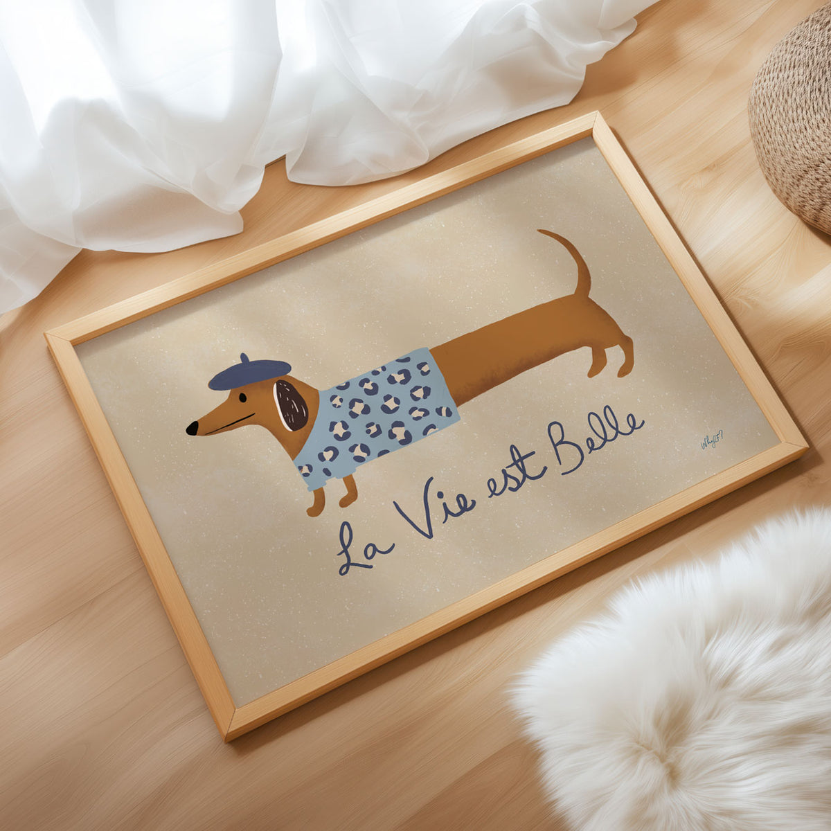 Landscape poster of a dachshund in a beret beside the words la vie est belle