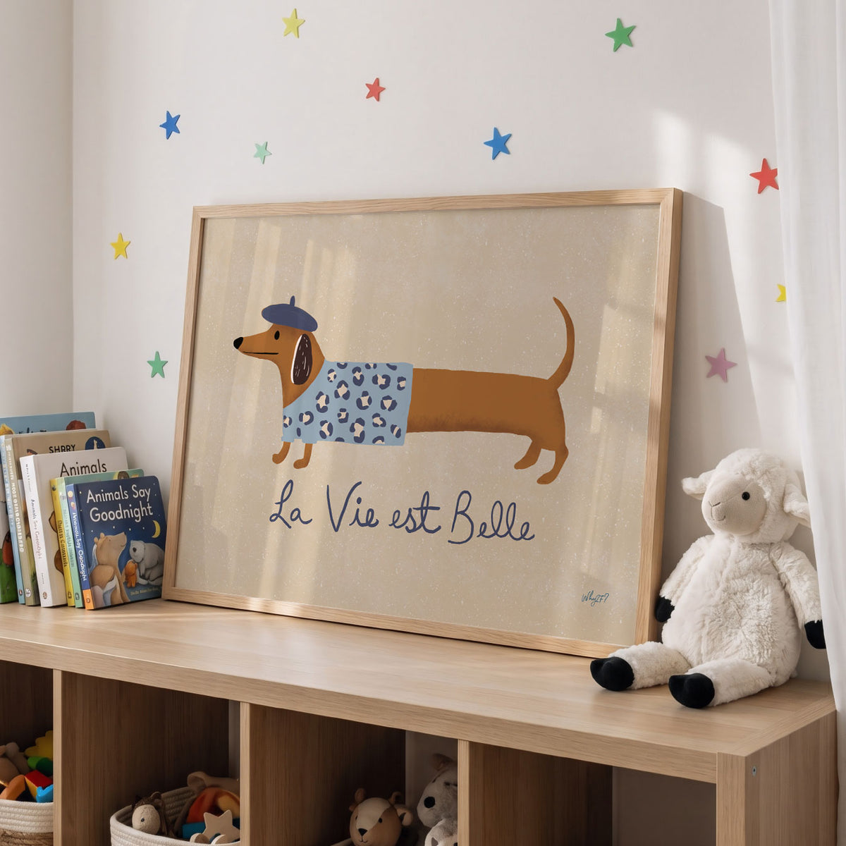 Landscape poster of a dachshund in a beret beside the words la vie est belle