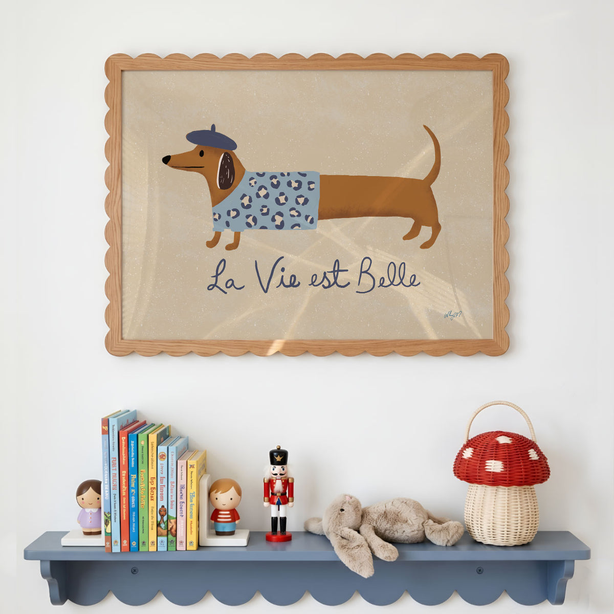 Landscape poster of a dachshund in a beret beside the words la vie est belle