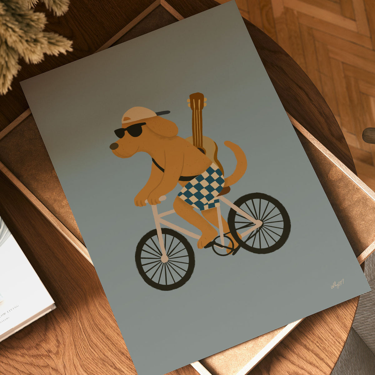 Bicycle wall art for kids with a brown dog riding a bike against a muted green background.