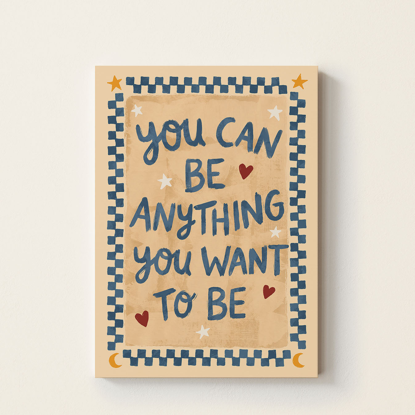 Inspirational typography poster featuring the phrase "You Can Be Anything You Want To Be" with decorative hearts and patterned border on a warm neutral background.