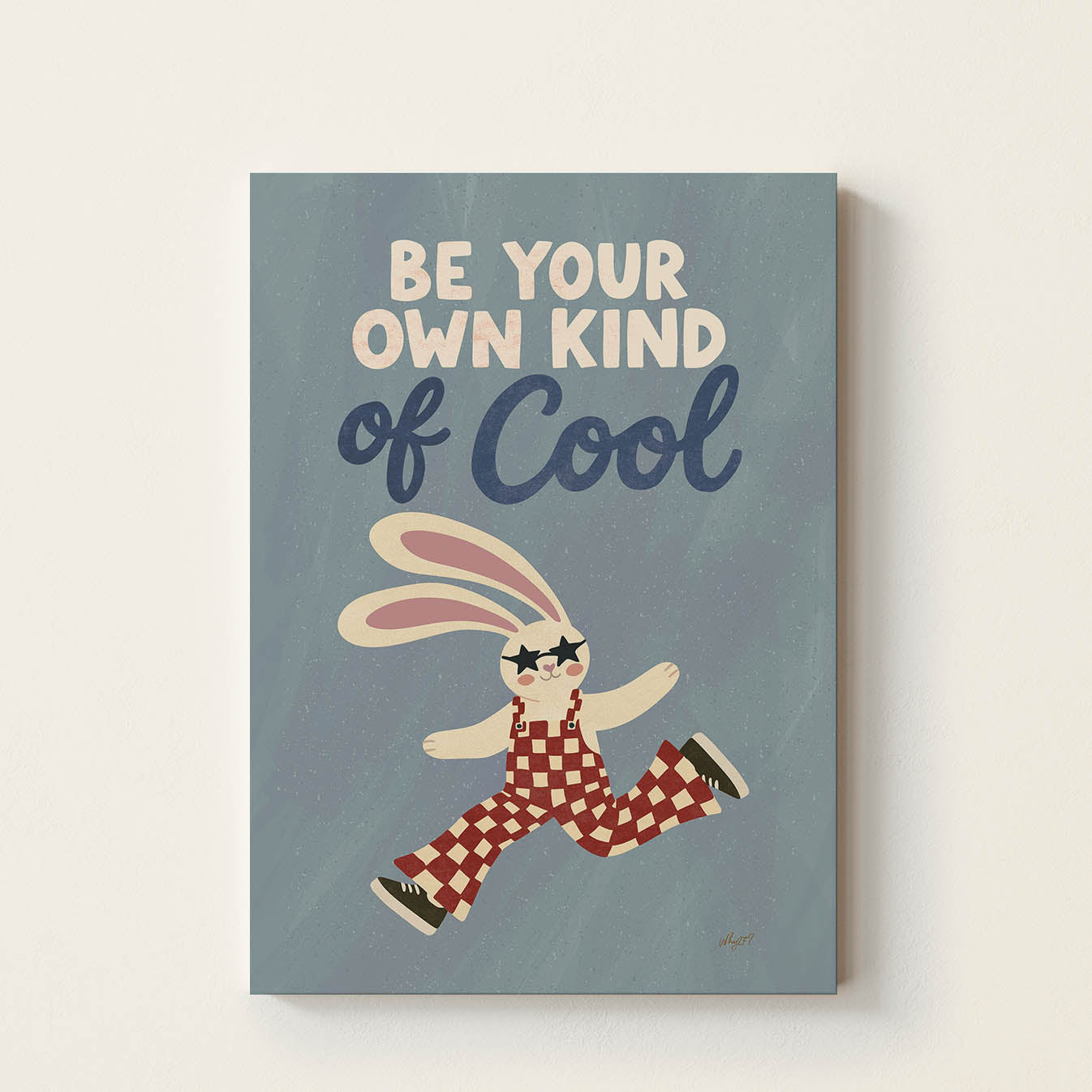 Hand-drawn bunny wearing star-shaped sunglasses and retro checkered overalls beneath the inspirational phrase "Be Your Own Kind of Cool", whimsical kids wall art for nurseries, bedrooms, playrooms, and classrooms.