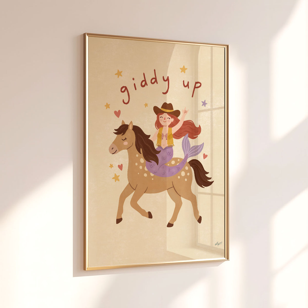 Hand-drawn mermaid cowgirl riding a spotted horse beneath playful Giddy Up lettering