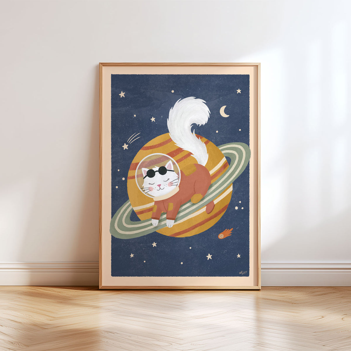 Illustrated poster of a white cat in a rust spacesuit lying on a golden ringed planet in a navy sky