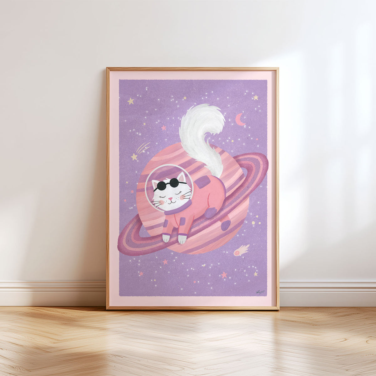 Illustrated poster of a white cat in a coral spacesuit resting on a pink ringed planet in a lilac sky
