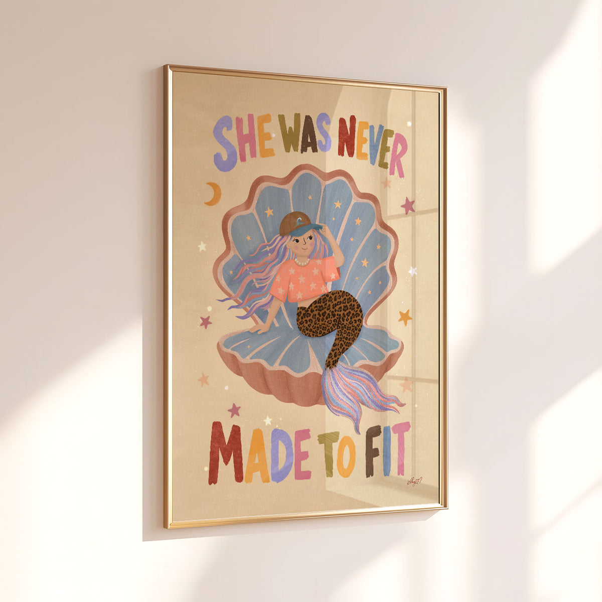 Illustrated poster of a mermaid in a shell wearing a cap with the words she was never made to fit