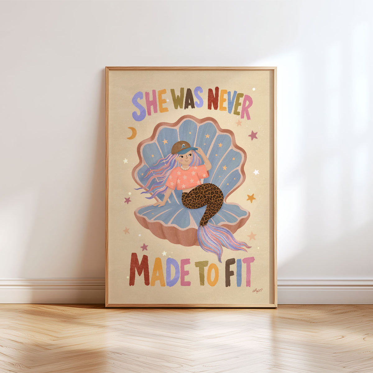 Illustrated poster of a mermaid in a shell wearing a cap with the words she was never made to fit