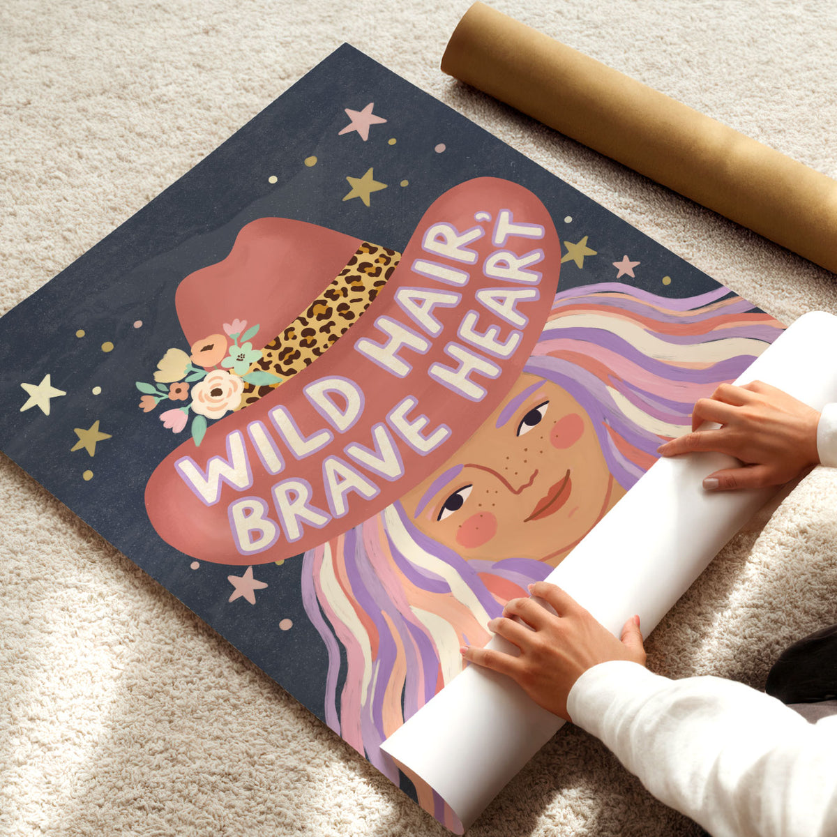 Illustrated poster of a girl in a pink cowboy hat lettered wild hair brave heart on a starry sky