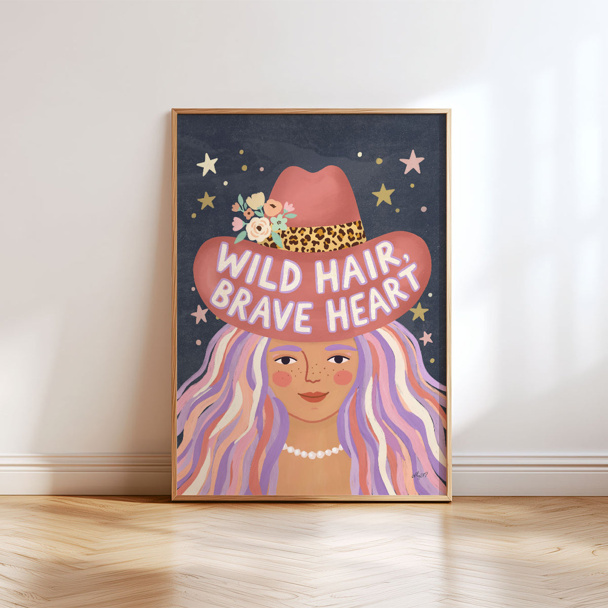 Illustrated poster of a girl in a pink cowboy hat lettered wild hair brave heart on a starry sky