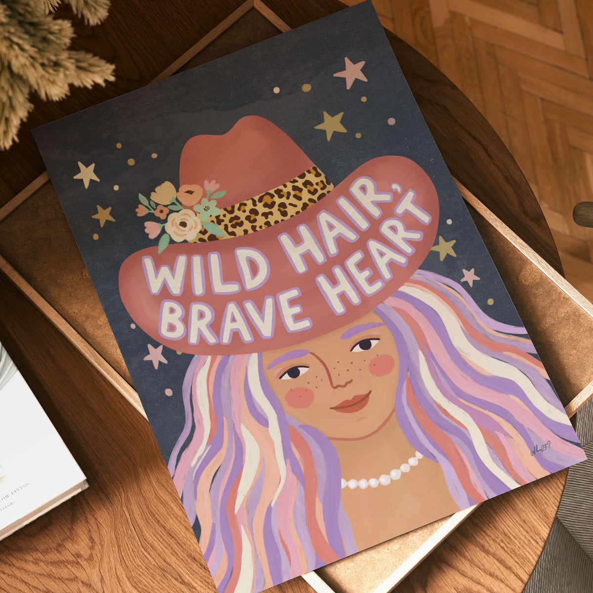 Illustrated poster of a girl in a pink cowboy hat lettered wild hair brave heart on a starry sky
