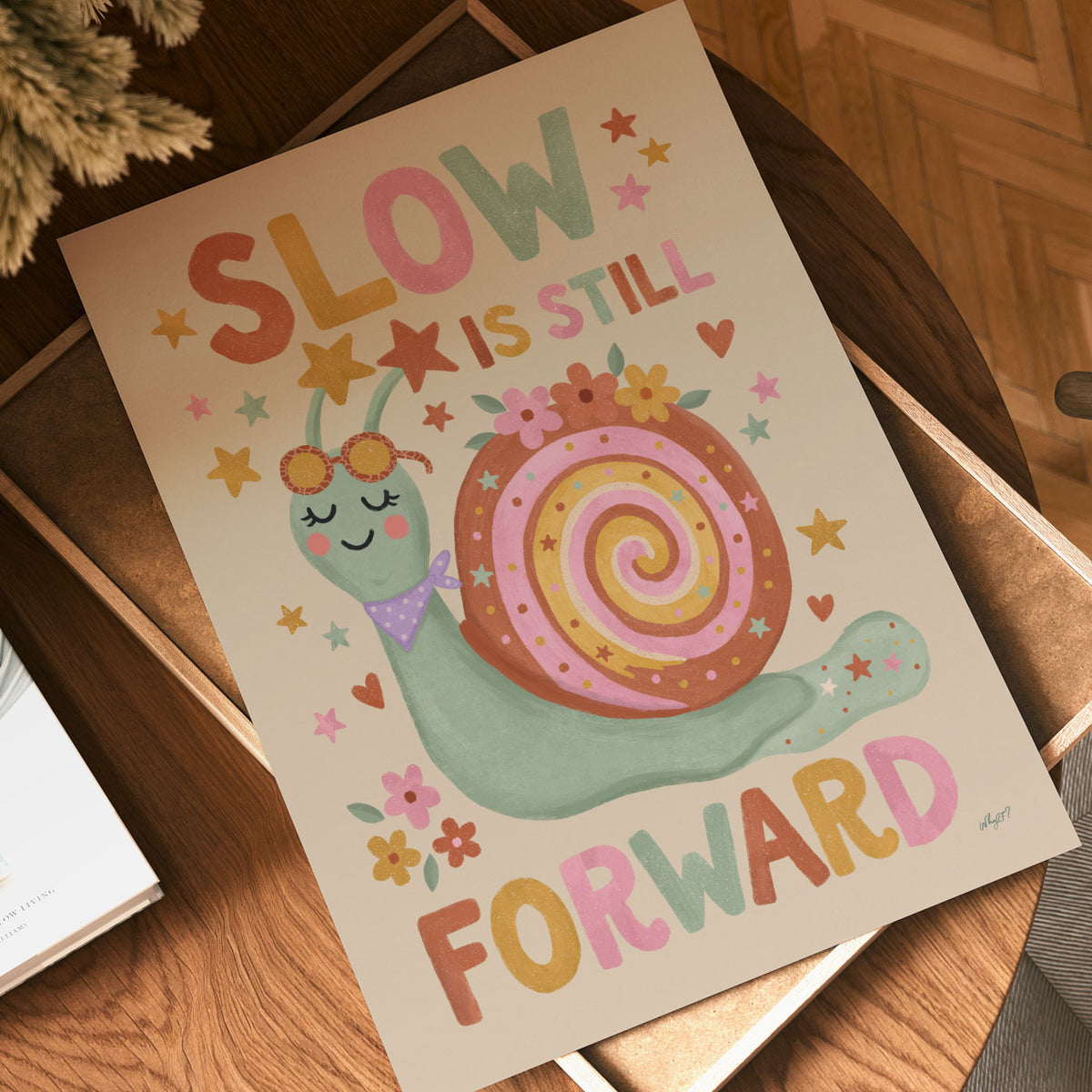 Illustrated poster of a smiling snail in sunglasses with the words slow is still forward