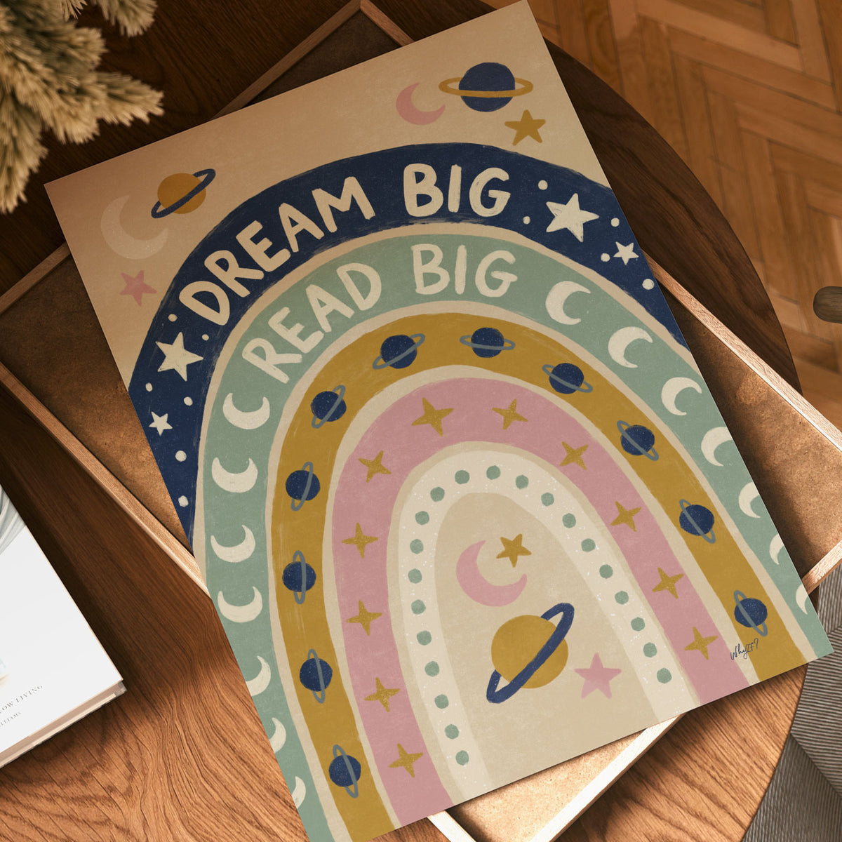 Illustrated poster of a rainbow filled with planets and stars lettered dream big read big
