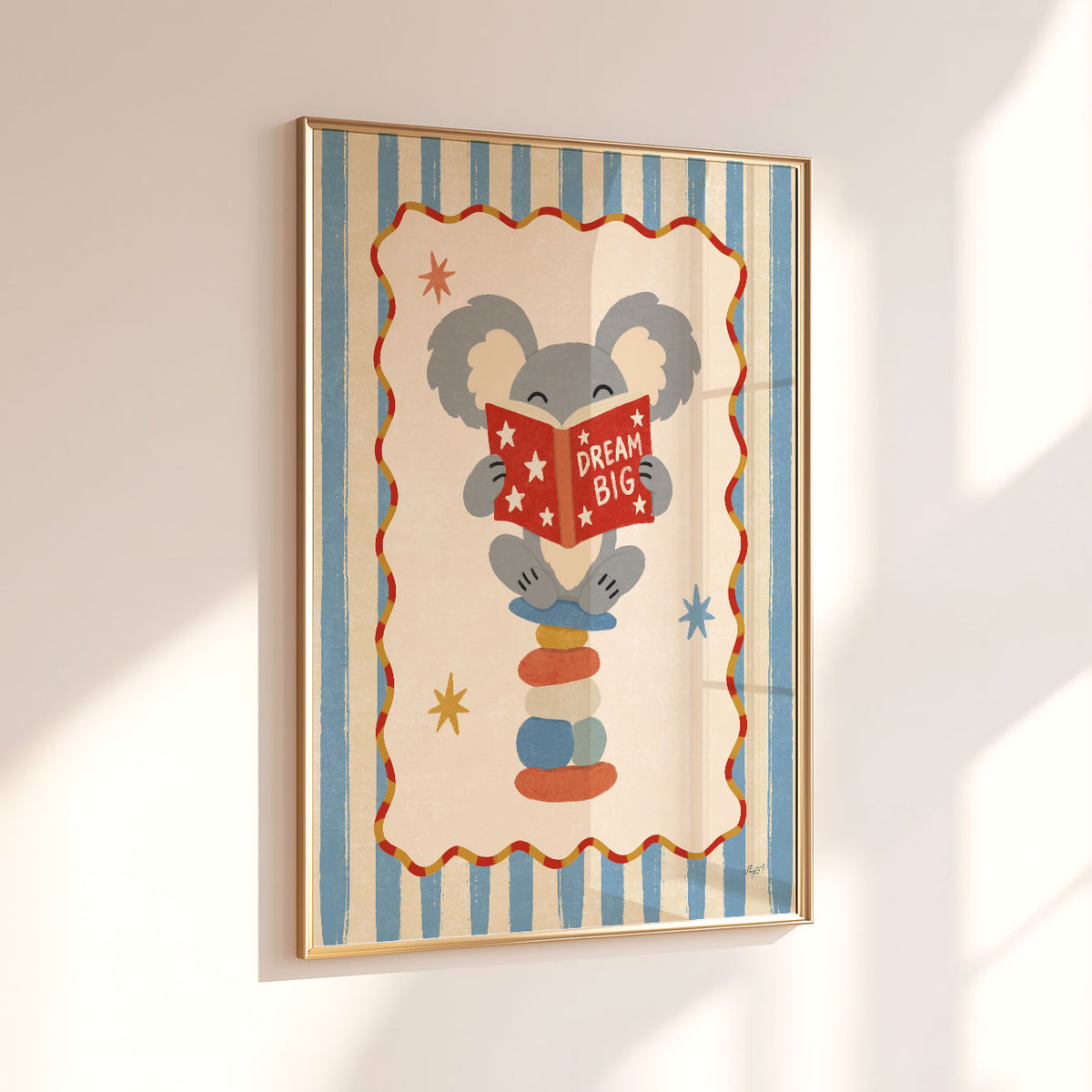 Illustrated poster of a koala on stacked stones reading a red book that says dream big