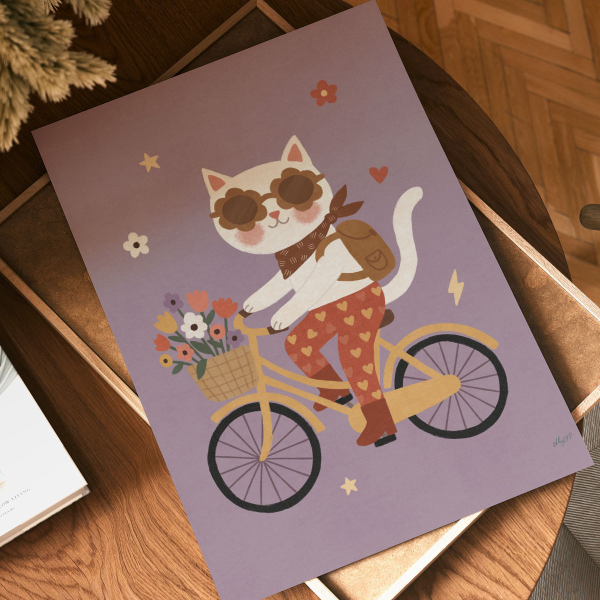 Illustrated white cat in flower-shaped sunglasses riding a yellow bicycle with a basket of flowers, on a dusty lilac background.