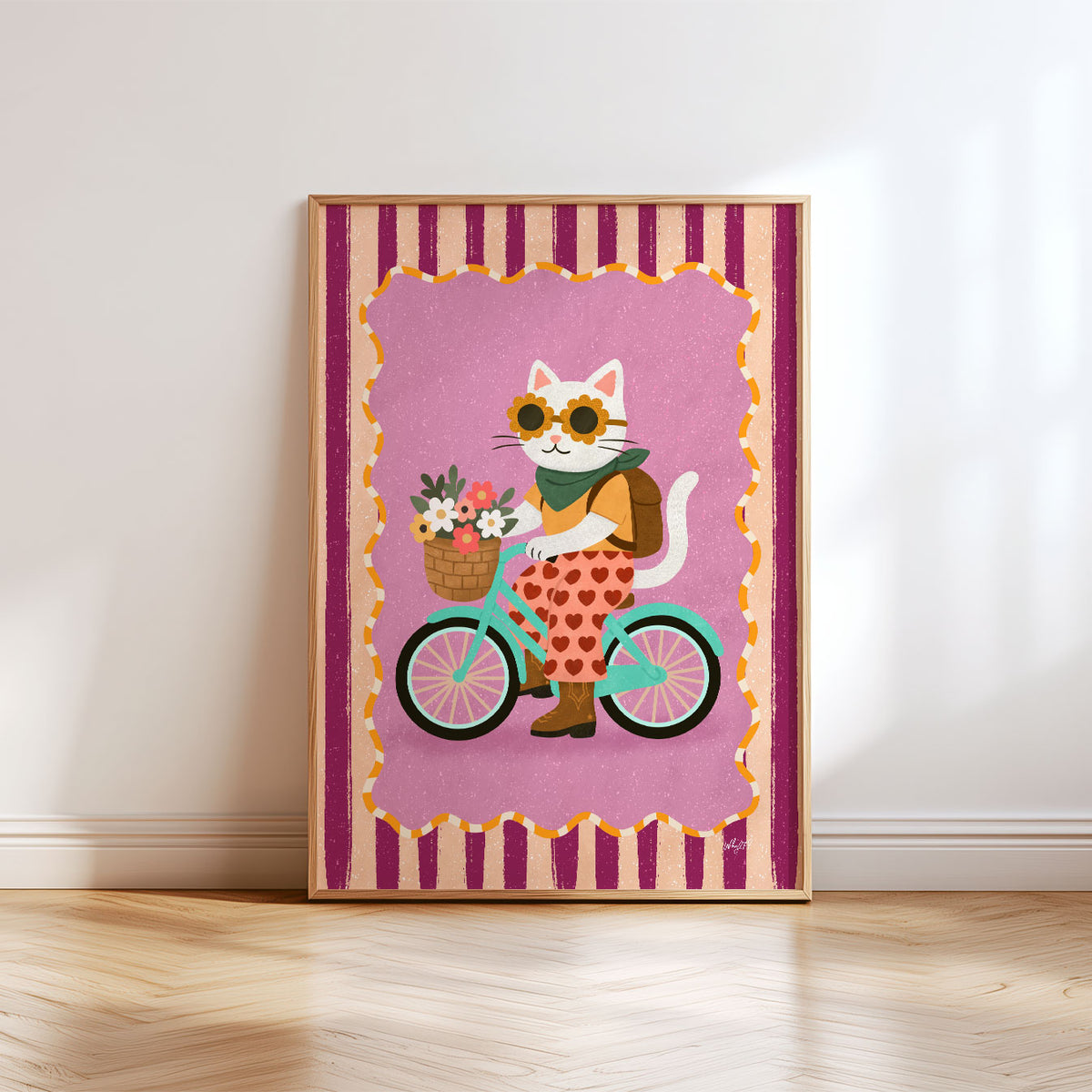 Playful cat riding a bicycle with flowers while wearing pink patterned trousers, boots and a green scarf.
