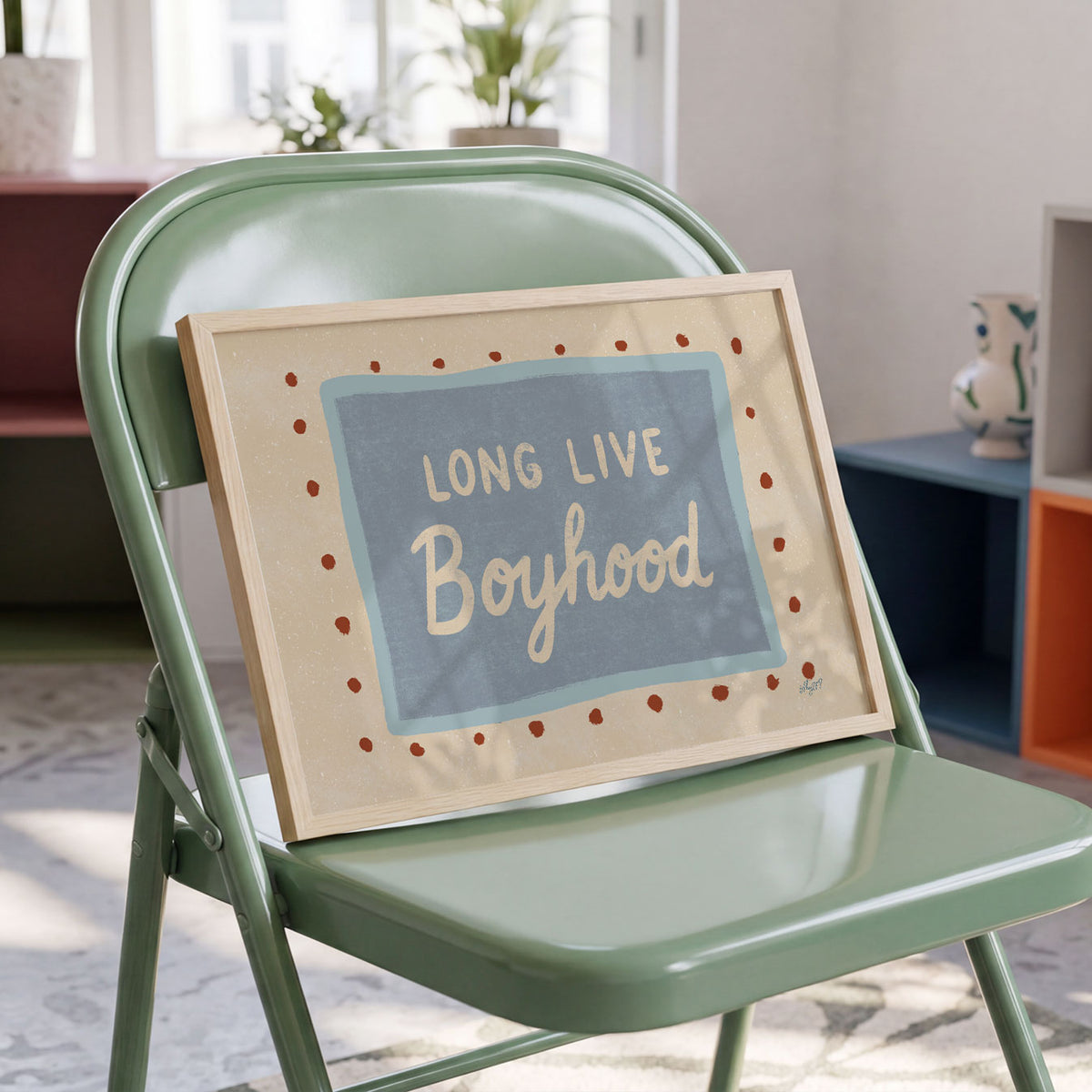 Landscape poster with the words long live boyhood on a blue panel with dotted border
