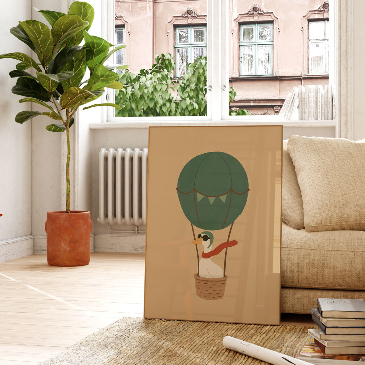 Whimsical goose flying in a deep green balloon with bunting and a brown basket on a warm tan background.