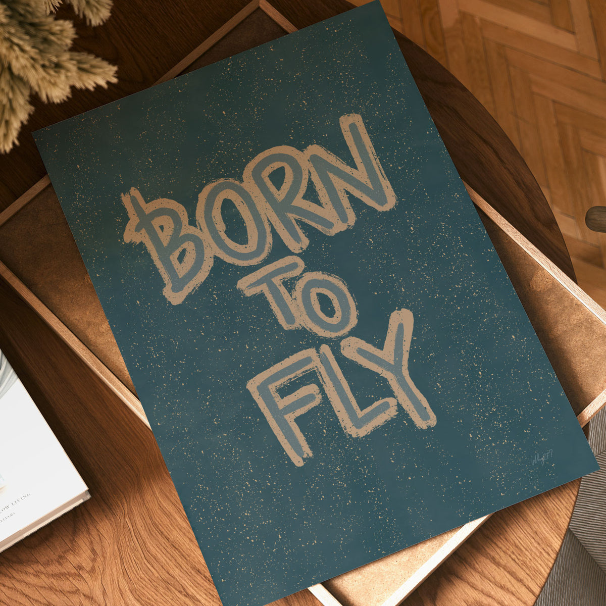 Retro-inspired typography wall art with the motivational phrase Born to Fly on a textured teal background.