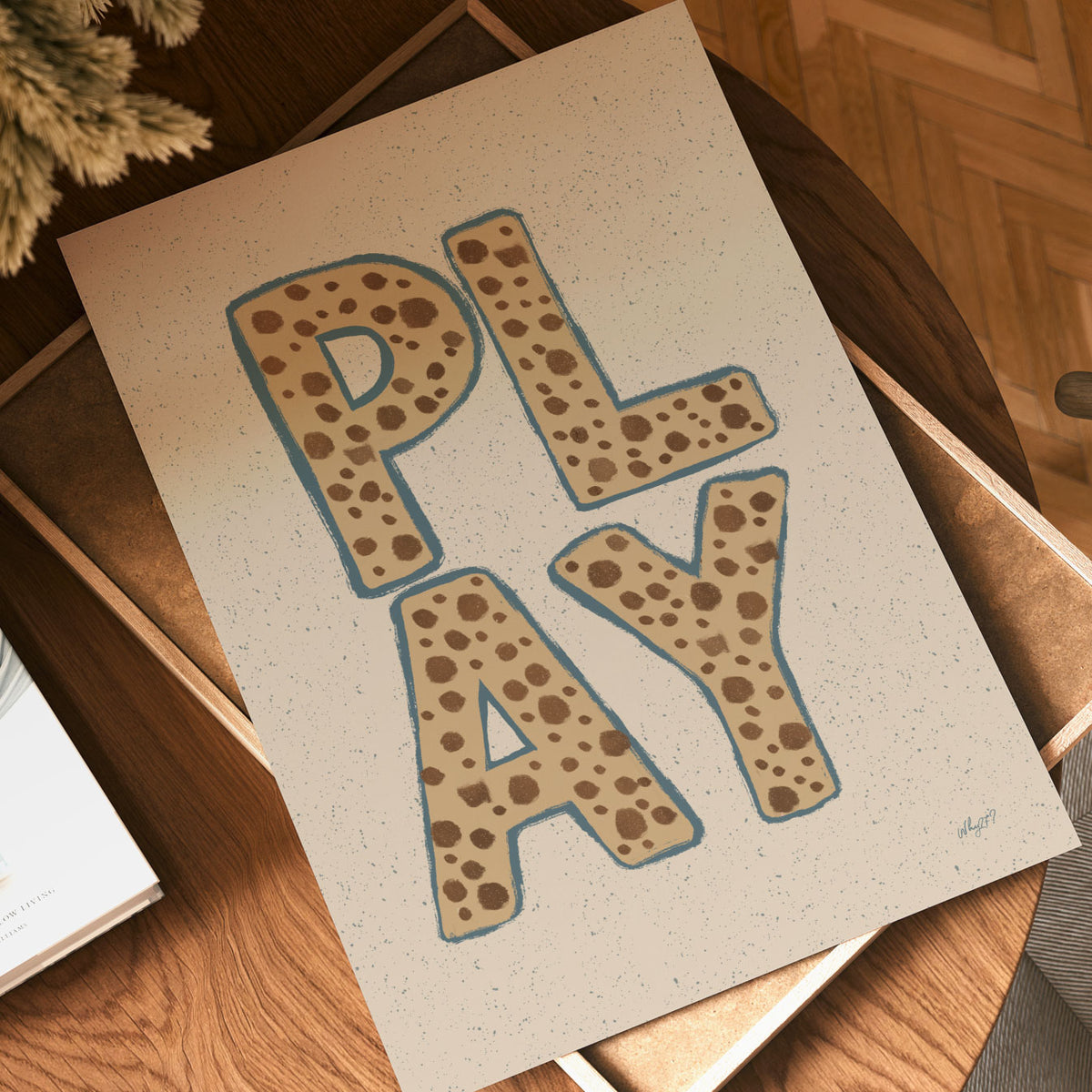 Playroom wall art featuring the word PLAY in bold brown animal-inspired patterned lettering.