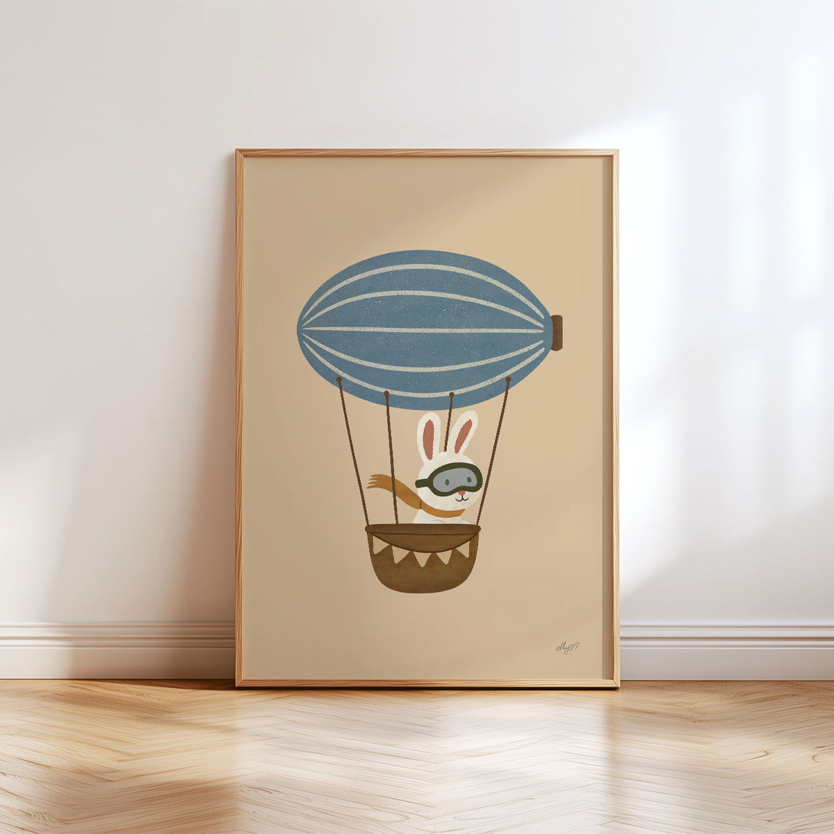 Vintage-inspired flying bunny illustration with pilot goggles, scarf and blue airship above a small basket.