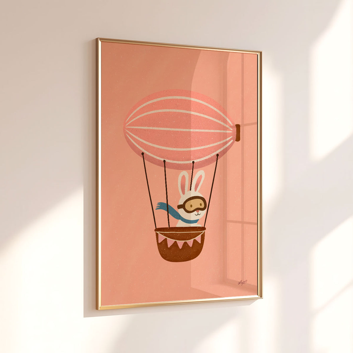 Kids adventure wall art with a white bunny wearing aviator goggles and a blue scarf in a hot air balloon.